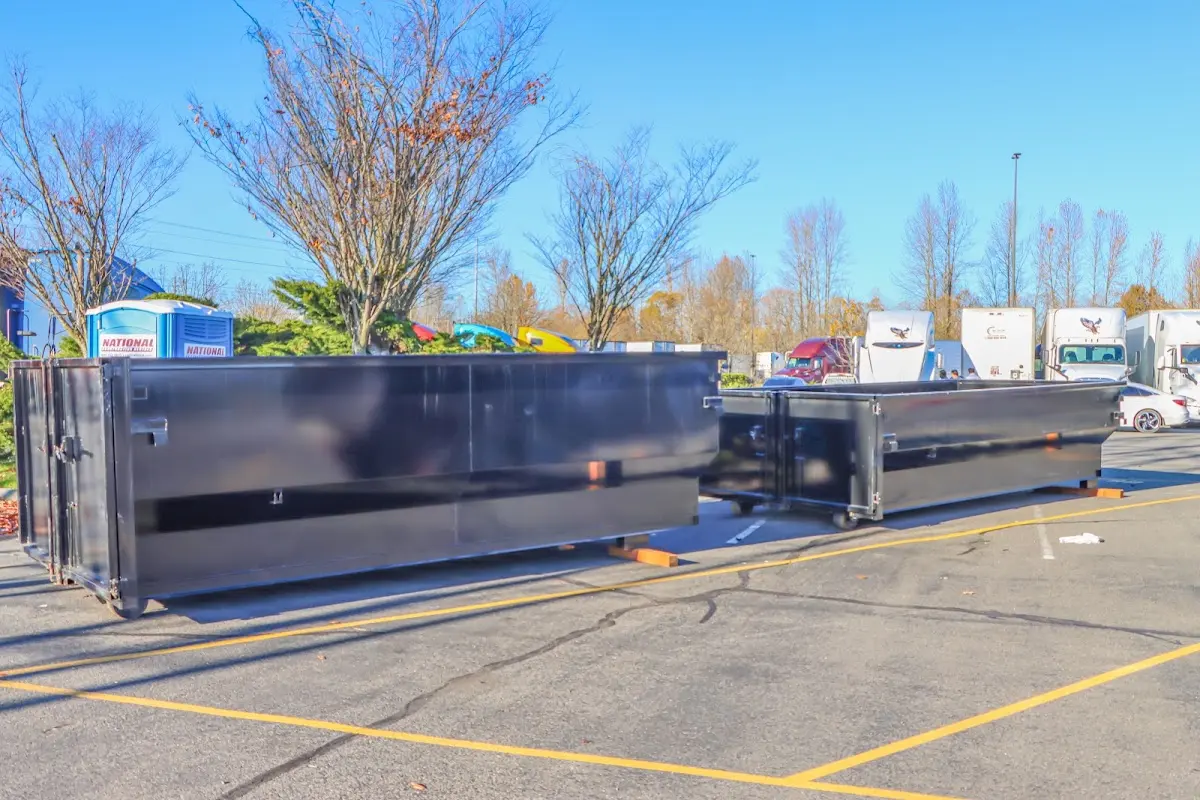 Professional dumpster rental service with roll-off container on residential driveway in Waimanalo